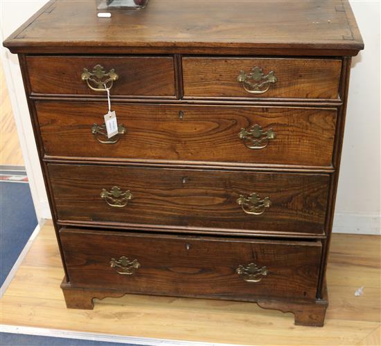 A George III elm chest, of two short and three long drawers W.89cm